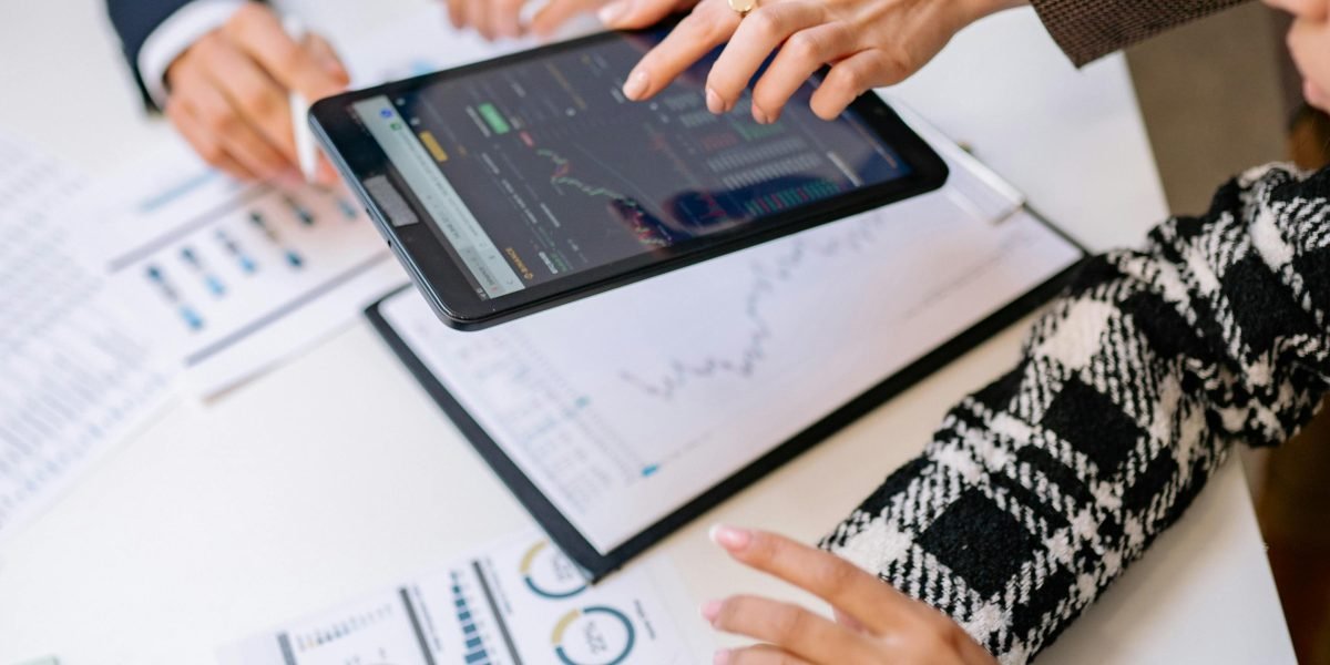 A diverse team engages in a focused discussion around a whiteboard, working to untangle the complexities of global AI compliance frameworks.