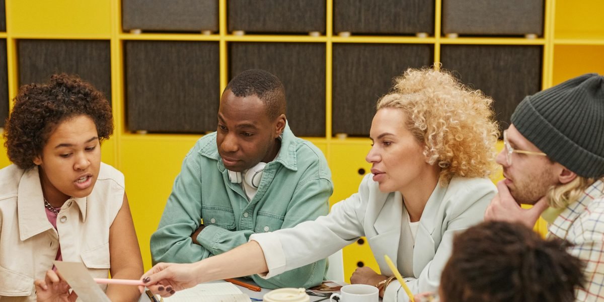 A diverse group of individuals engaged in a serious discussion, representing the complex ethical considerations like bias in AI imaging.