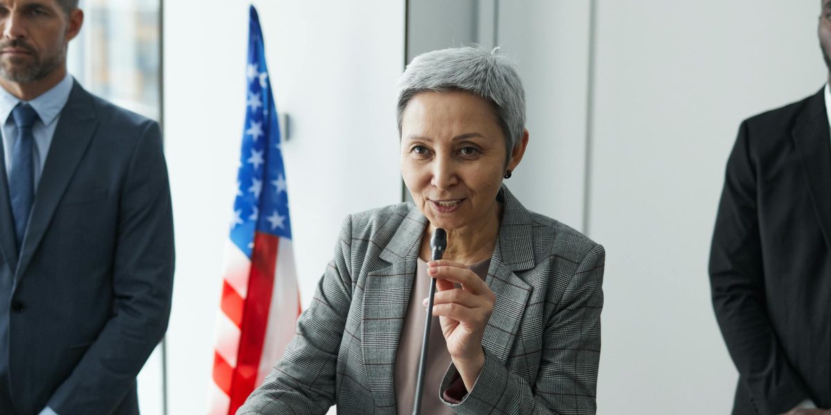 A smiling government official engaged in a meeting, representing the positive outcomes and confidence gained from successful tech implementations.
