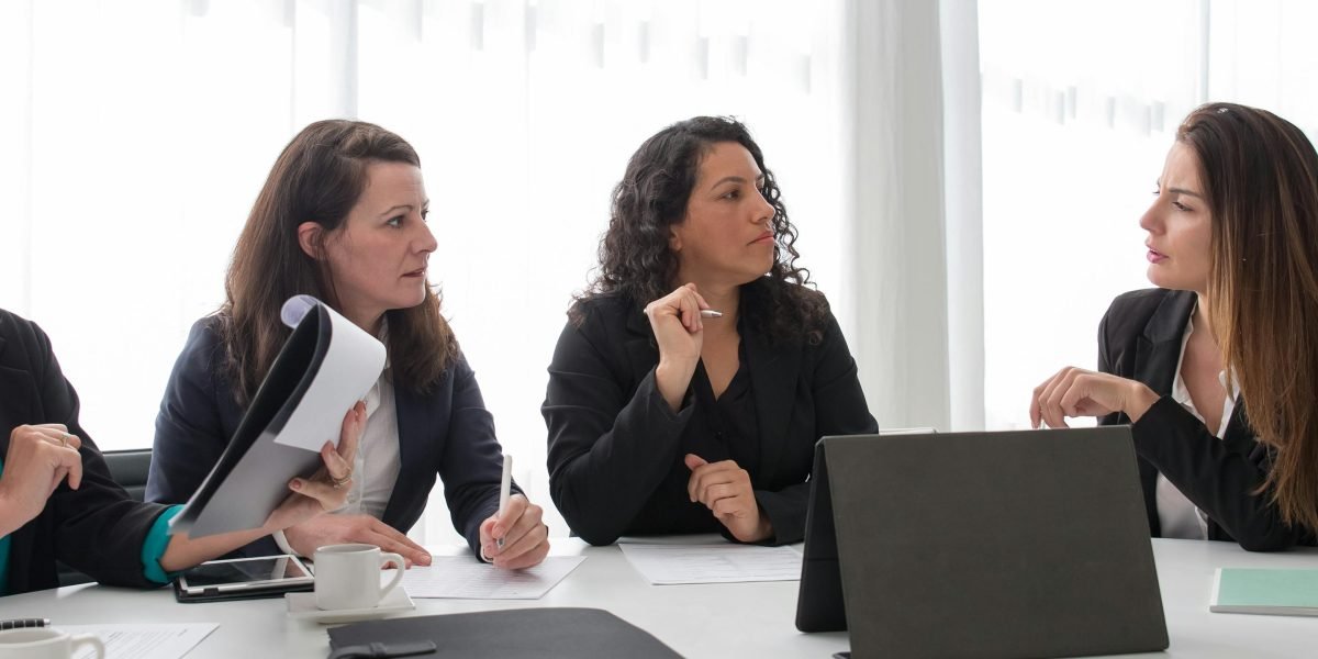 Leaders review the potential and implications of AI website builders in a strategic meeting.