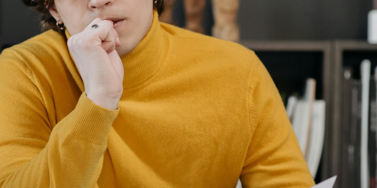 A person contemplating a difficult choice, reflecting the ethical dilemmas and legal challenges in AI content creation.