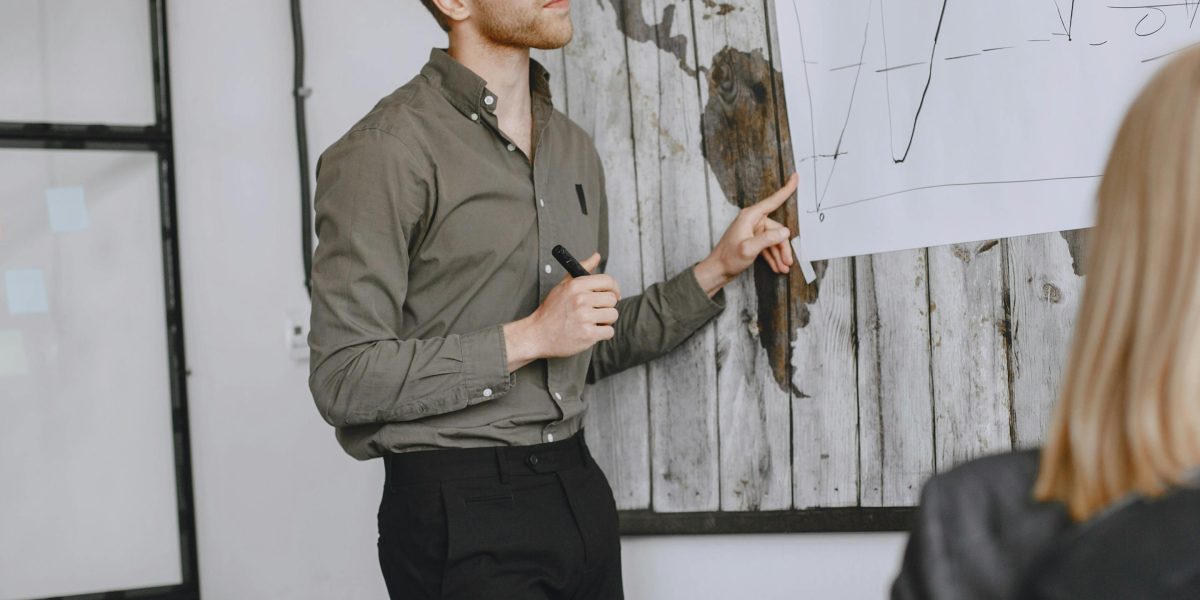 A professional facilitating an AI training workshop, explaining complex concepts to engaged participants.