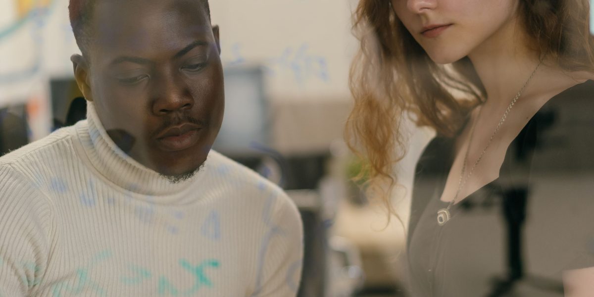 A diverse team engaging in a serious discussion about the ethical implications of AI development and use.