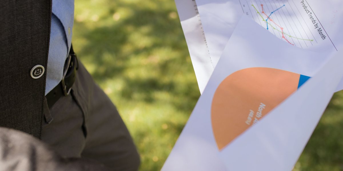 A business leader reviews detailed forecasts to make informed strategic decisions.