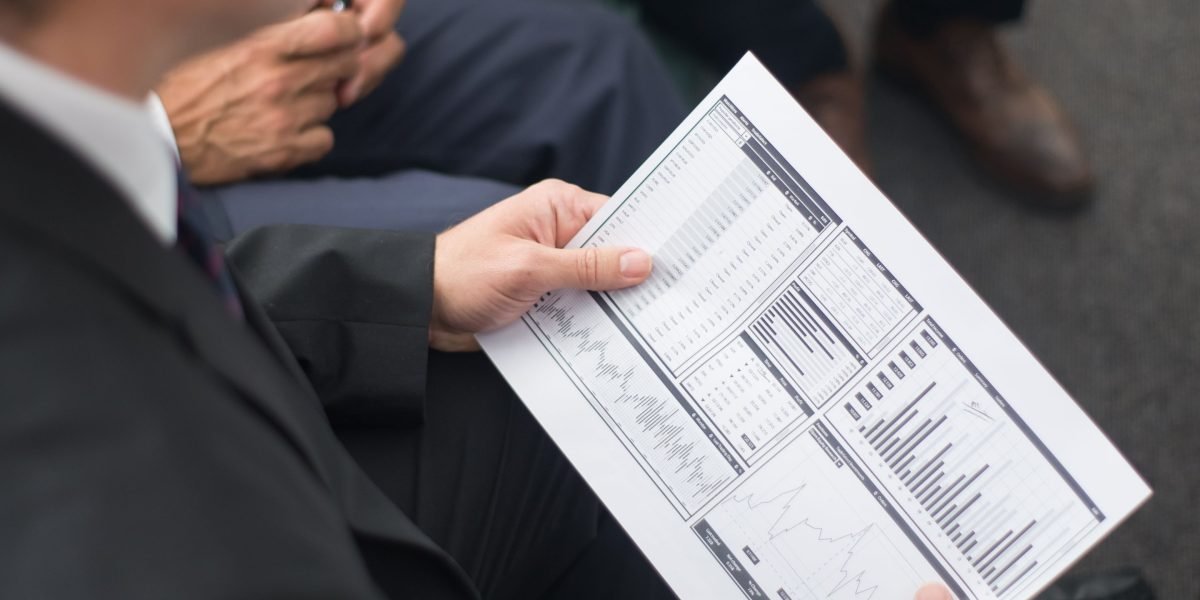 Investors carefully examining a business plan, reflecting due diligence for AI startup funding.