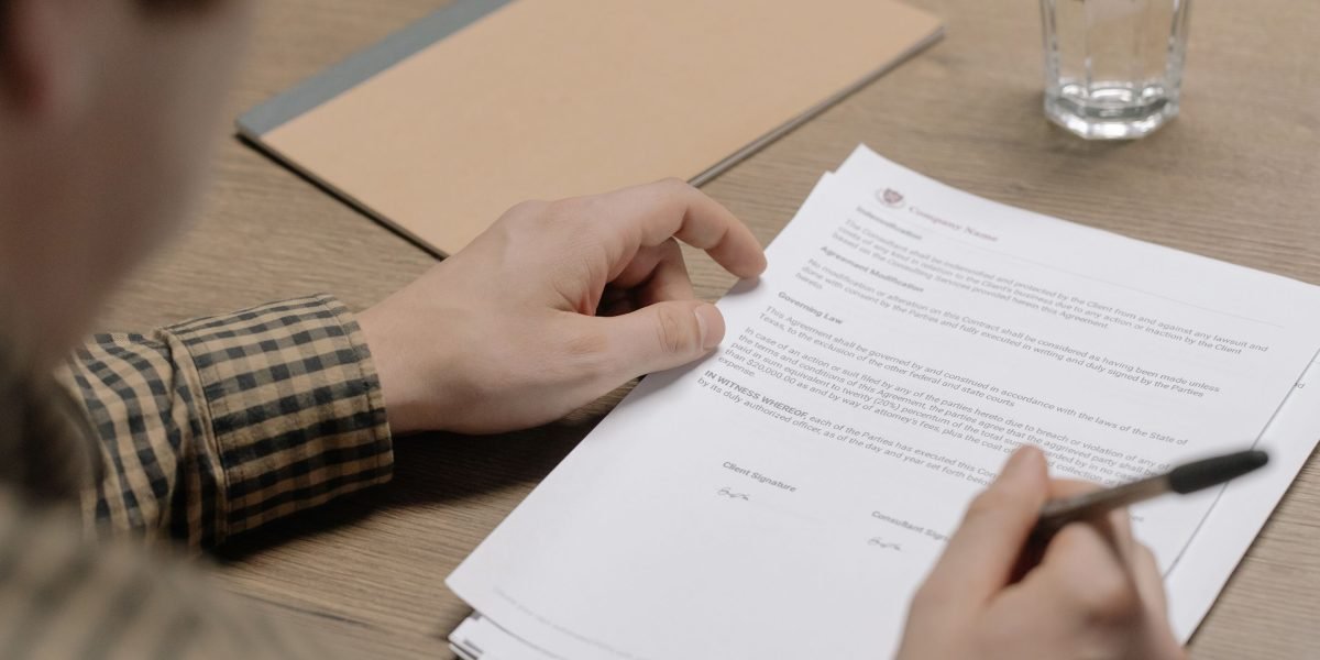 A professional meticulously reviews legal and regulatory documents to ensure AI system compliance.
