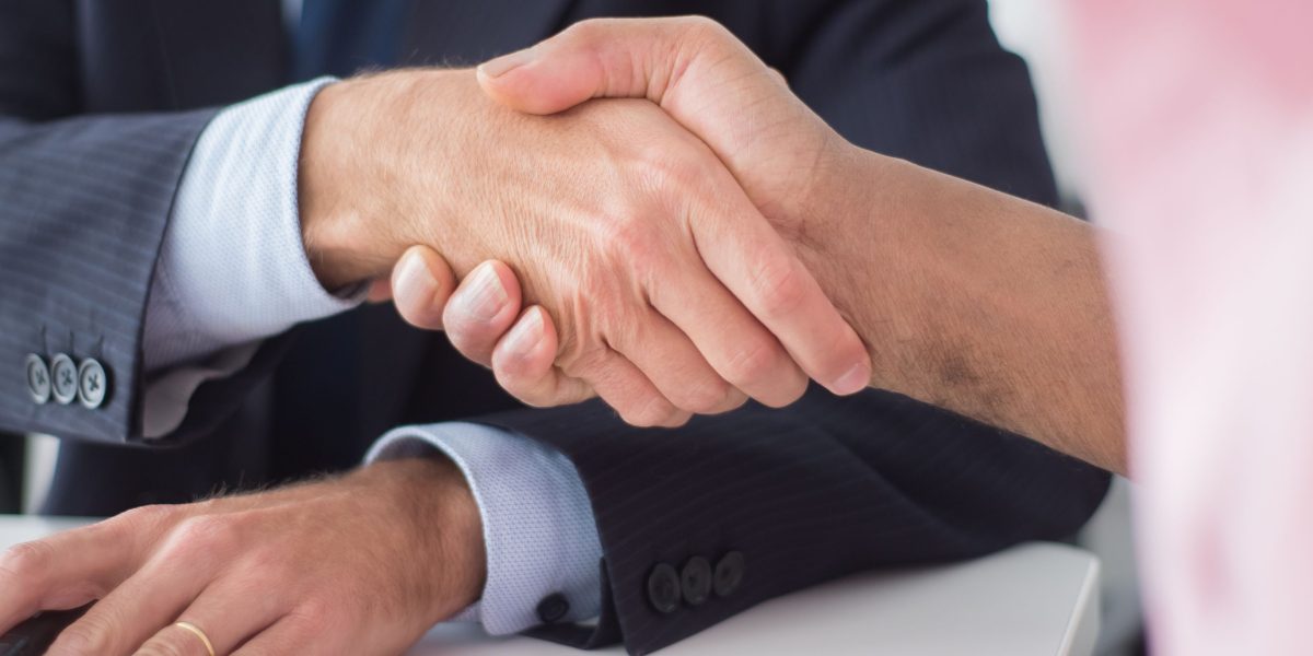 Investors engage in discussions, emphasizing the critical role of compliance in strategic business decisions and valuation.