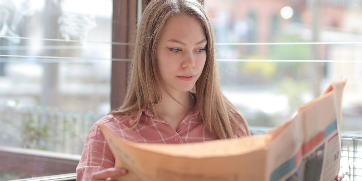 A person thoughtfully reading, symbolizing the desire to move beyond headlines for deeper insights.