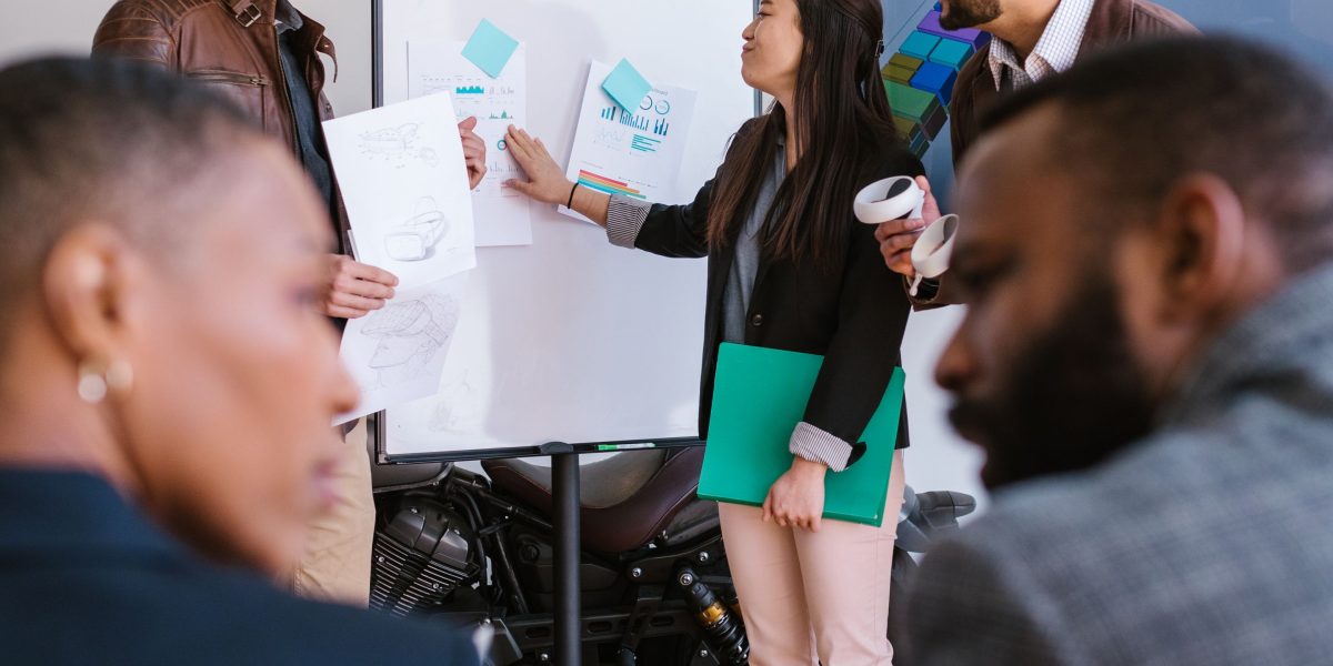 Attendees engaging in a lively discussion at a tech conference, highlighting the value of face-to-face interactions for regulatory insights.