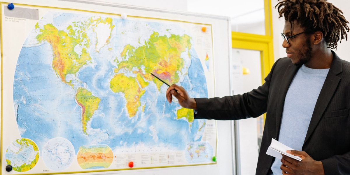 An individual studying a complex map, symbolizing the challenge of navigating intricate regulatory landscapes.
