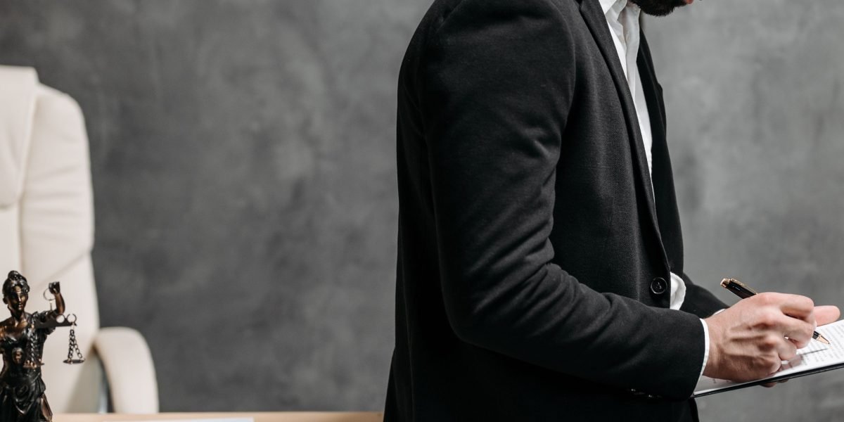 A person thoughtfully reviewing complex legal documents, symbolizing the challenge of navigating regulations.
