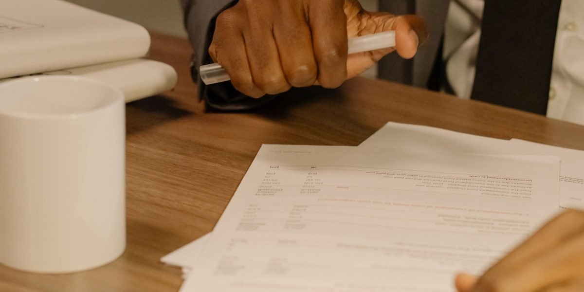 A professional meticulously reviews documents to ensure AI-generated content meets compliance standards.