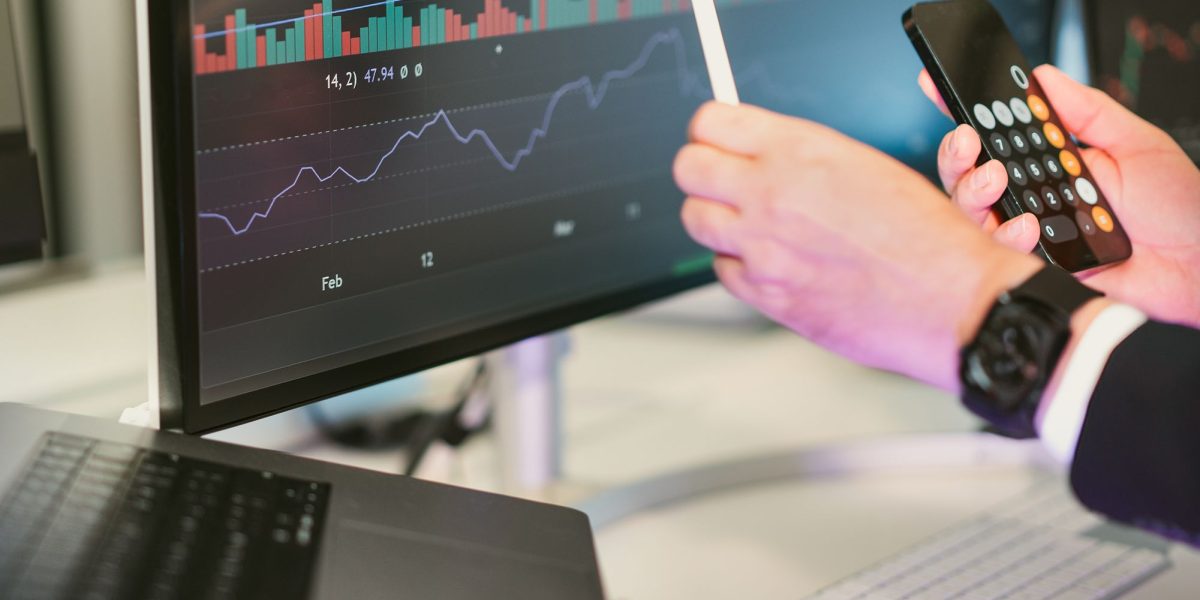 A person diligently analyzing financial charts and data, representing an investor assessing regulatory risks and company performance.