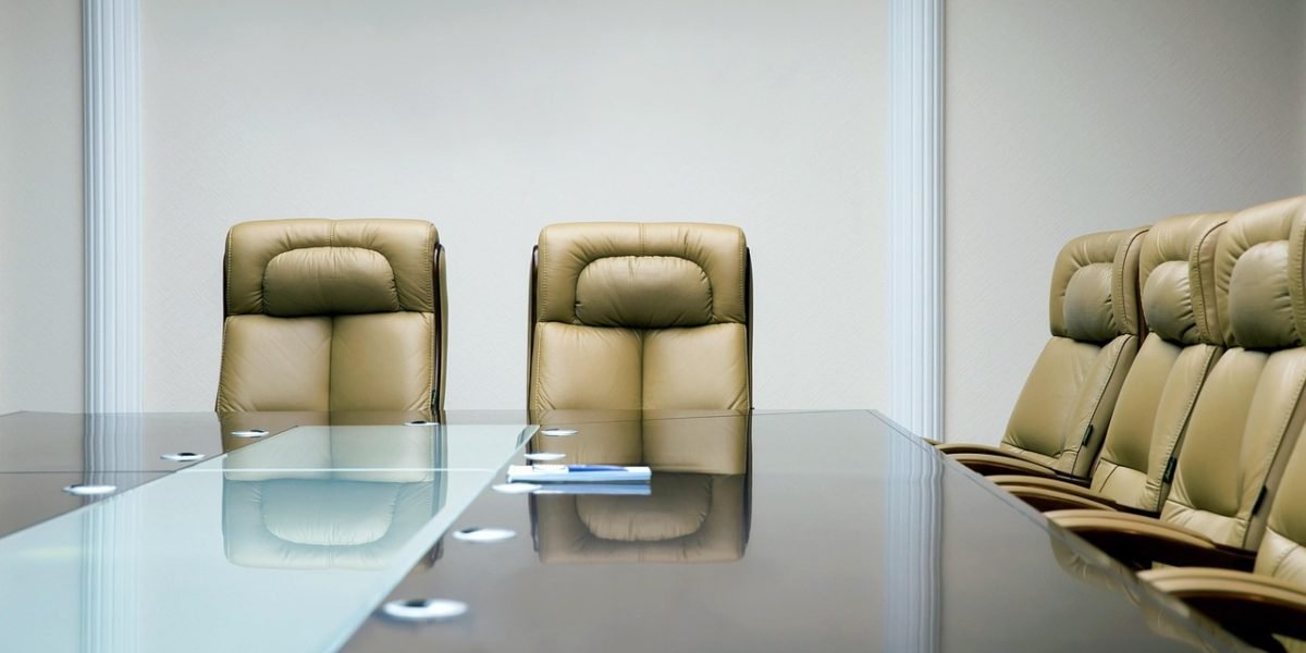 An executive team presenting to a corporate board, symbolizing the translation of AI trends into strategic business plans.