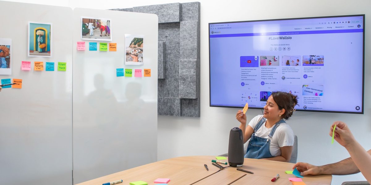 A small team actively collaborating and brainstorming solutions to complex AI technical challenges using a whiteboard.