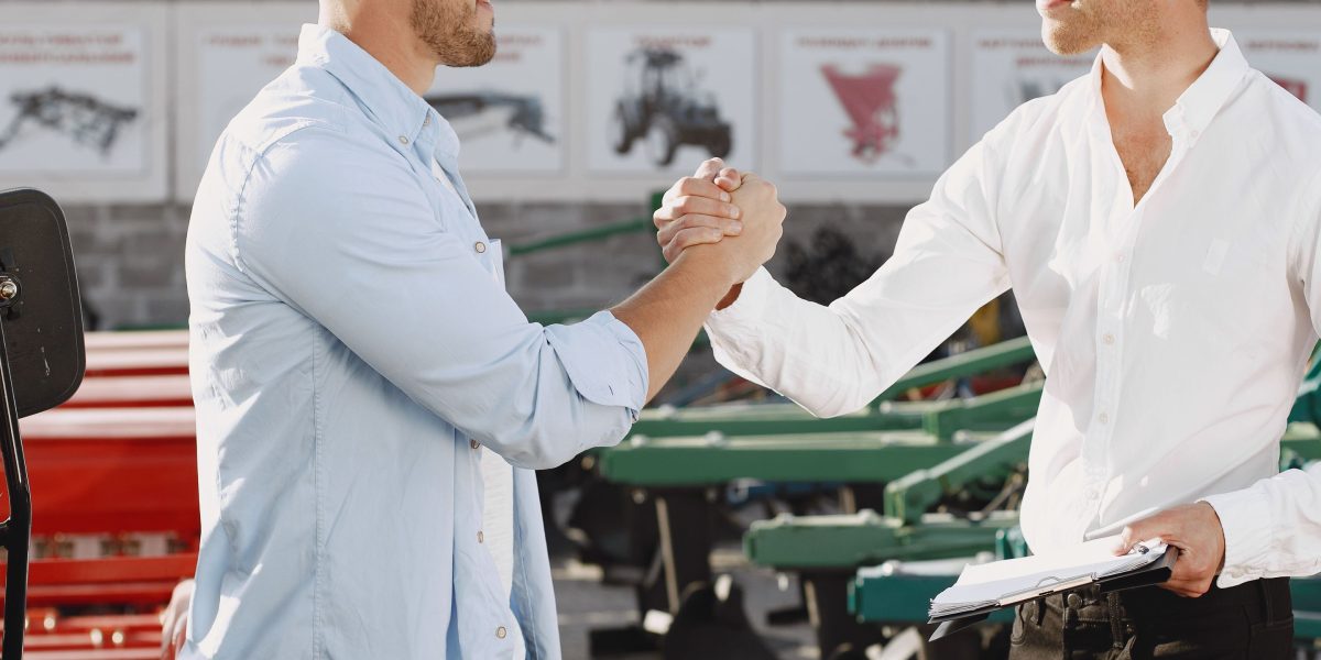 Two professionals sealing a deal with a handshake, symbolizing a successful and carefully vetted investment in AI technology.