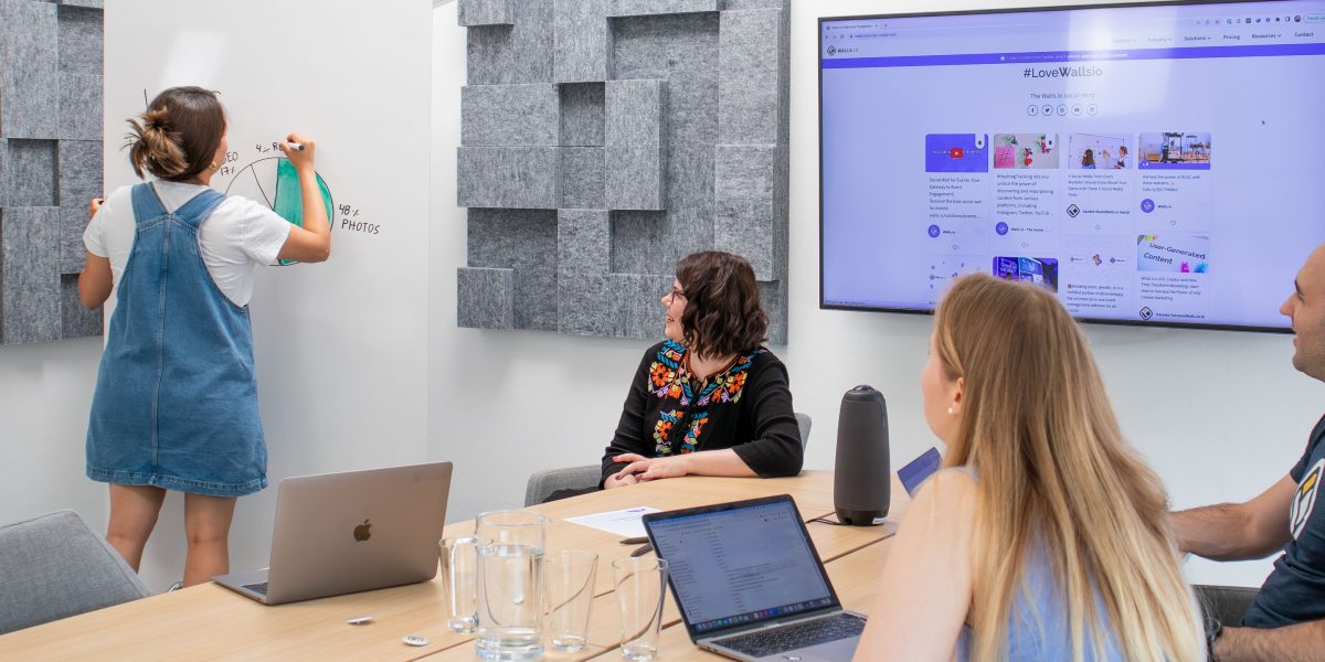 A team collaborating around a whiteboard, mapping out strategic plans for AI governance, risk assessment, and future regulatory changes.