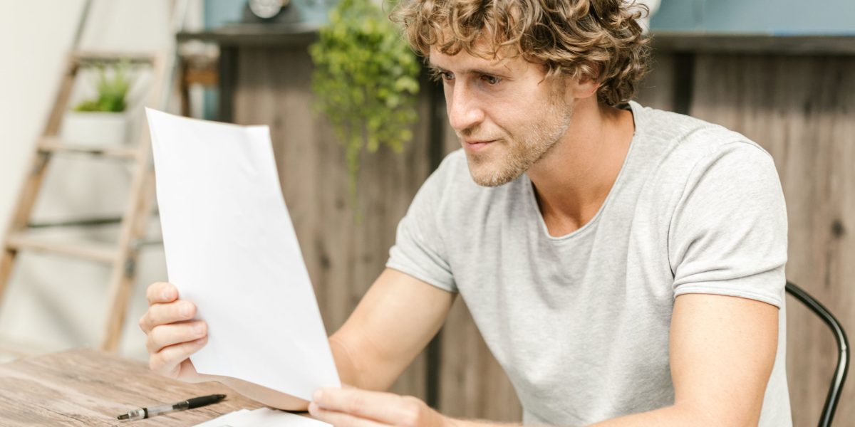 A focused professional meticulously reviewing documents, symbolizing attention to detail in data quality and privacy.