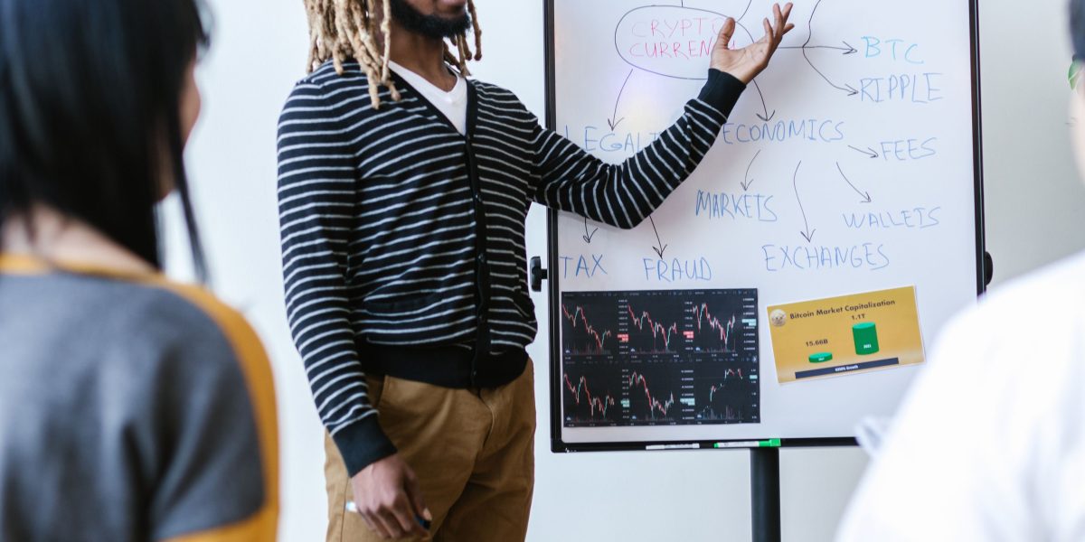 Startup founders collaborating, using a whiteboard to strategize and adapt their product plans to new market rules.