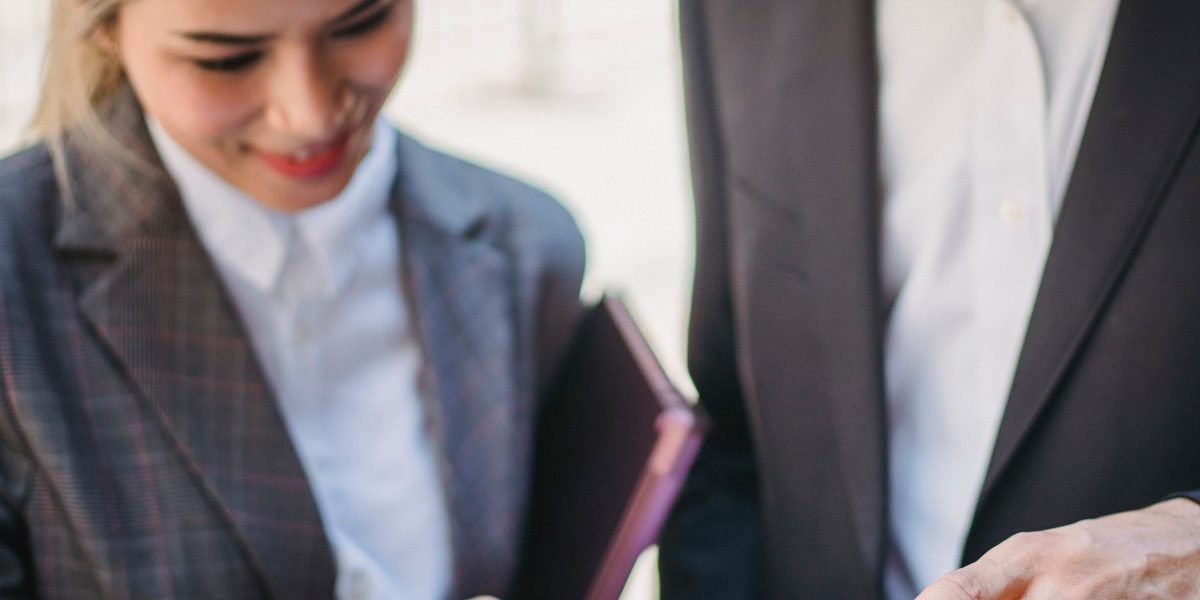 A team of executives meticulously reviewing documents, symbolizing the due diligence process during mergers and acquisitions.