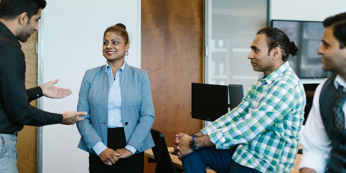 A team collaborating in an office setting, representing how different roles interpret and discuss tech policy updates.