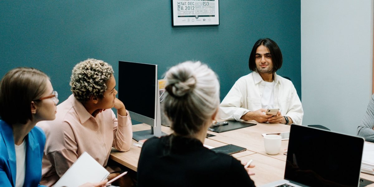 A group of professionals engaged in a serious discussion, representing a focus on ethical considerations in AI design and implementation.