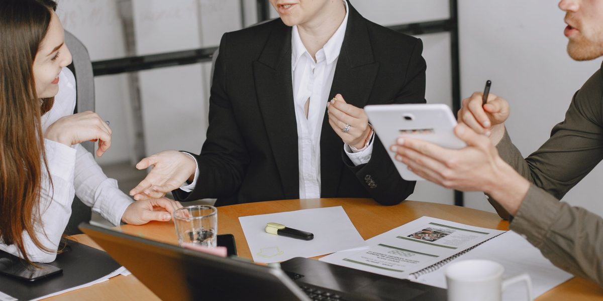 Executives, investors, and legal teams in a meeting, discussing new technology and business strategy.