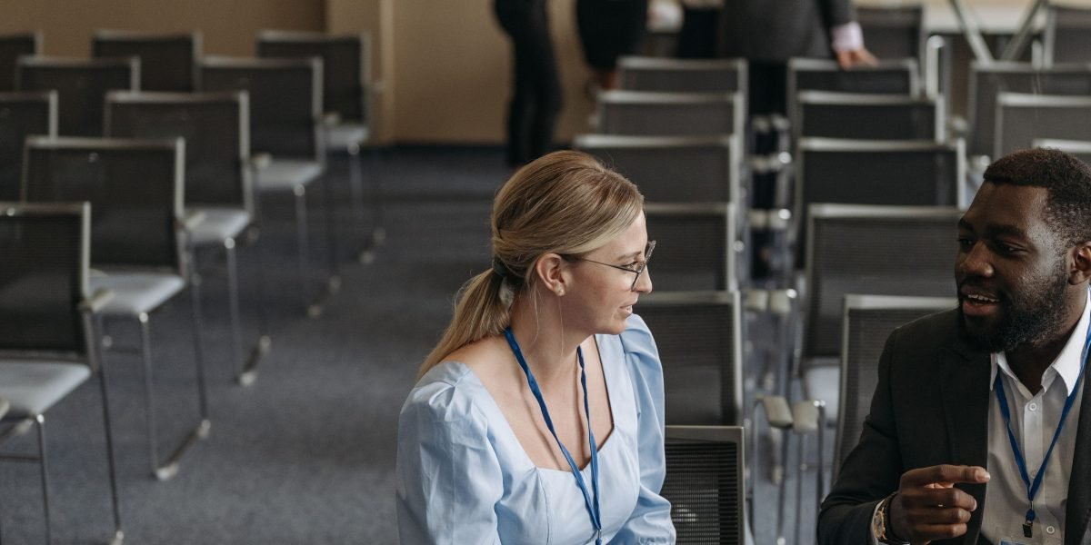 Diverse professionals engaging in conversation at a large technology conference.