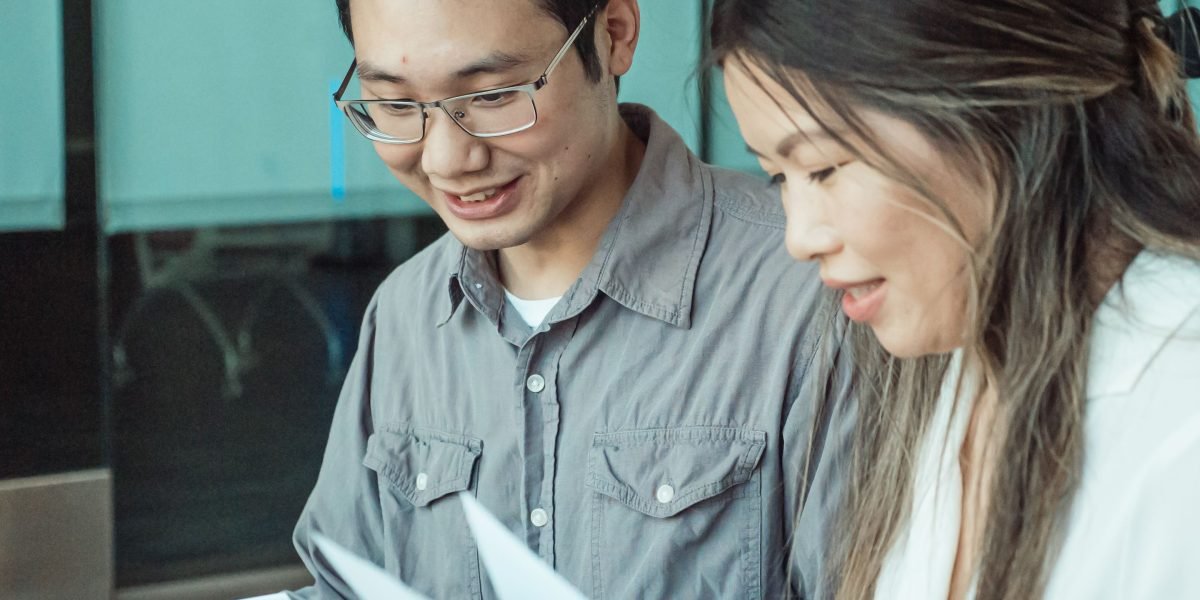 A team collaborates while reviewing academic papers, building a strong foundation in AI safety understanding.