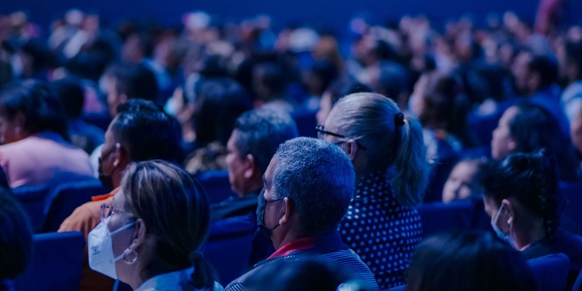 Attendees actively networking and discussing key topics at a bustling technology conference.