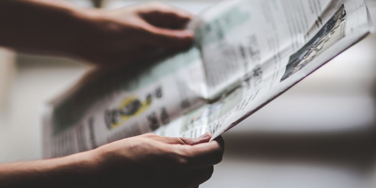 Individuals engaging with news on various digital platforms, from smartphones to tablets, reflecting modern news consumption habits.