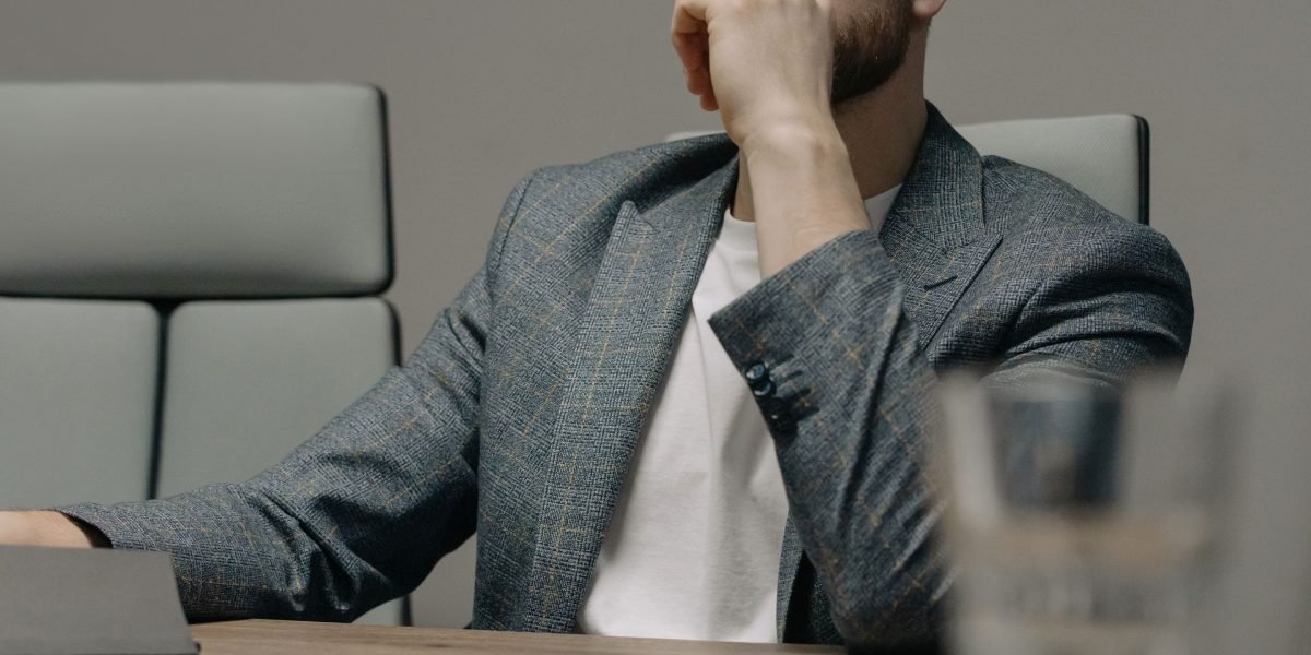 An individual looking thoughtfully at a document or projection, representing the challenge of understanding and adapting to new regulations.