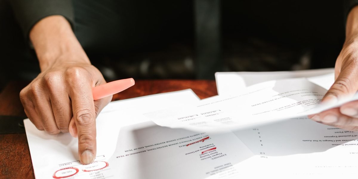 Executives in a professional setting, diligently reviewing financial reports and documents during an important discussion.